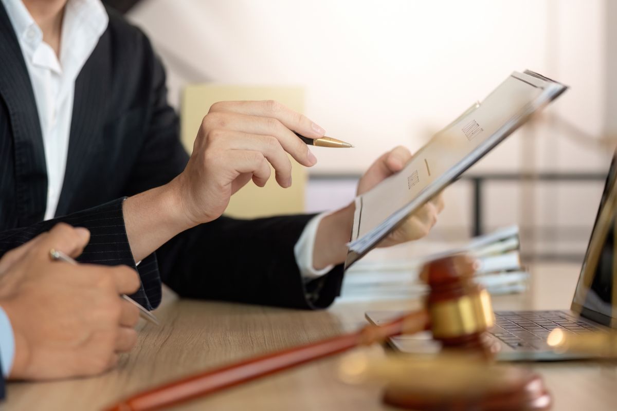 A lawyer holding documents while discussing legal advice.