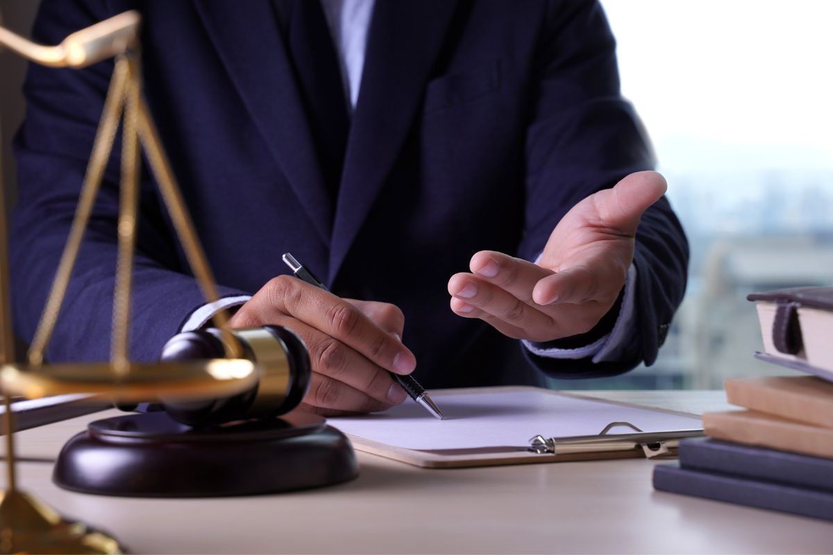 A lawyer sitting at a desk with legal documents. A lawyer sitting at a desk with legal documents.