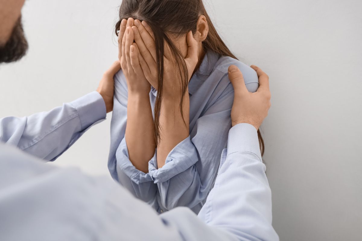 Woman covering face during harassment Woman covering face during harassment.