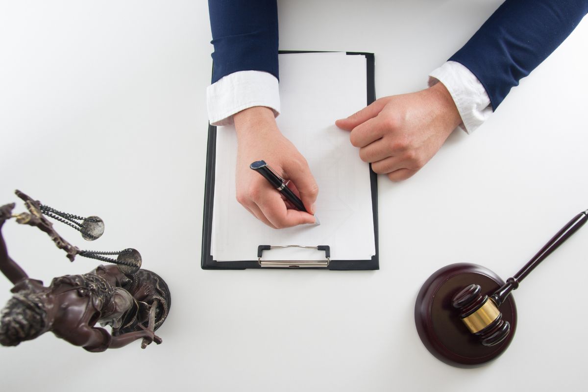 Lawyer reviewing and signing legal documents. Lawyer reviewing and signing legal documents.