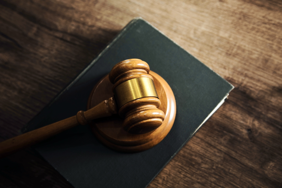 Wooden gavel lying on a law book