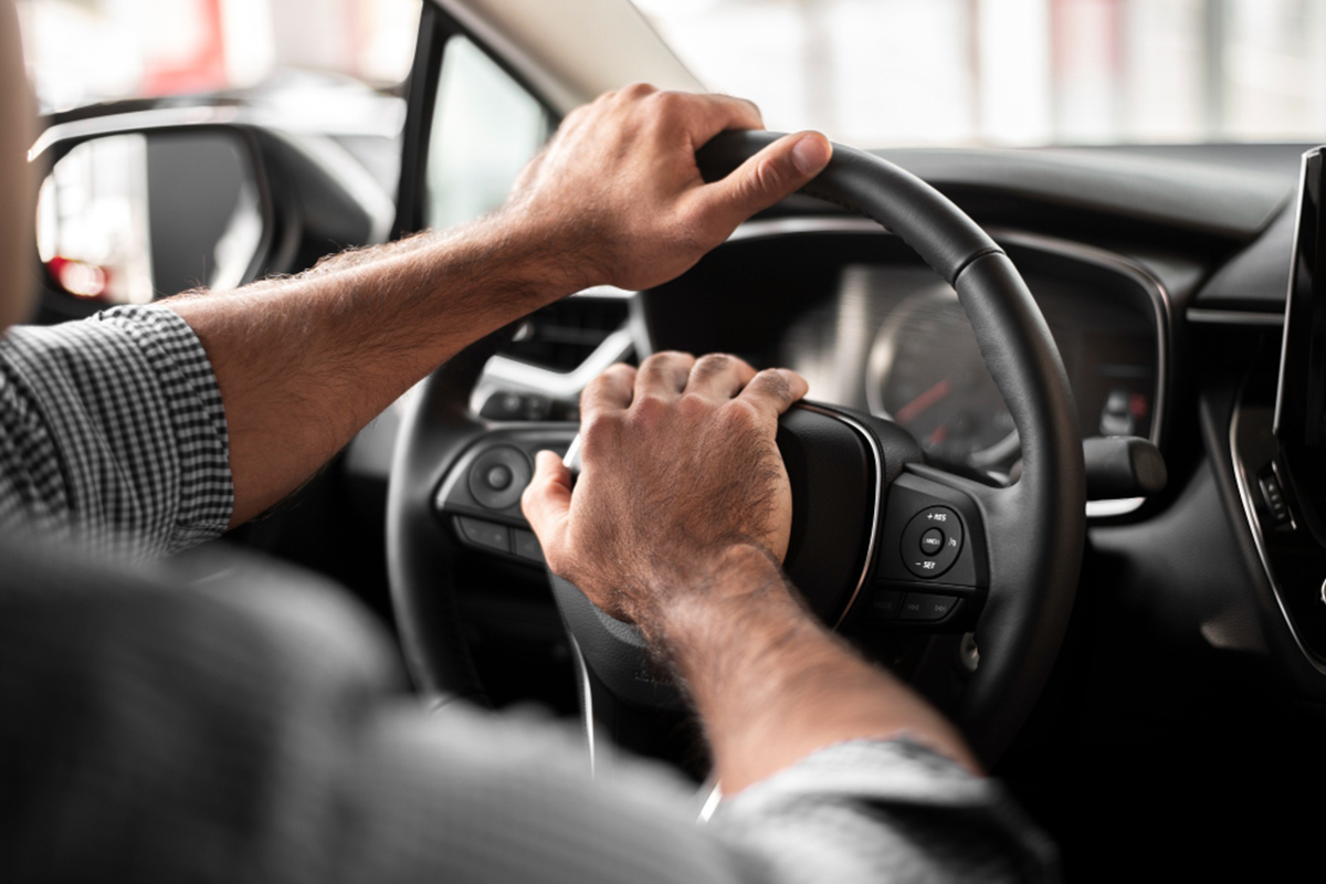 A man honks his horn in traffic