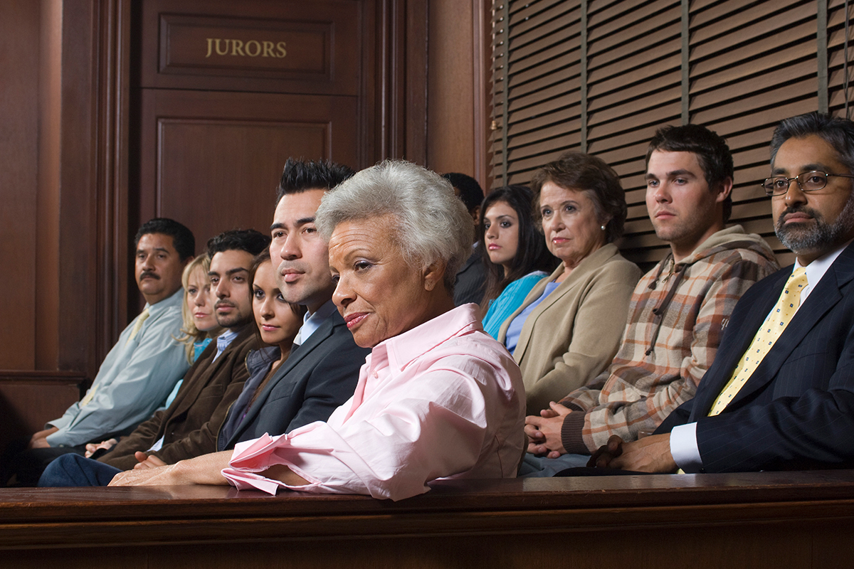 A jury listening to oral arguments from a lawyer
