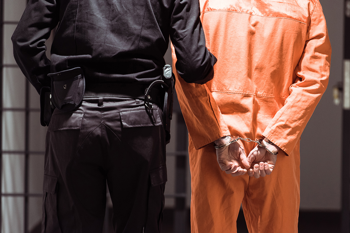 A man in handcuffs in prison