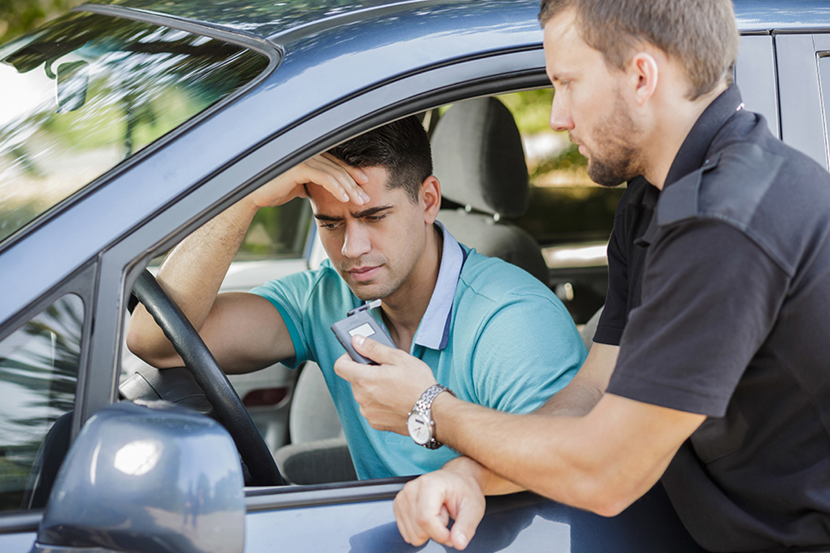 A police officer with a young man pulled over