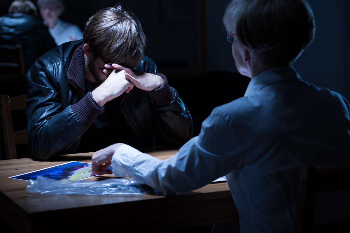 A police officer interrogates a person
