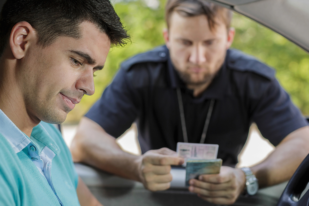 A peace officer issues a traffic ticket to a driver