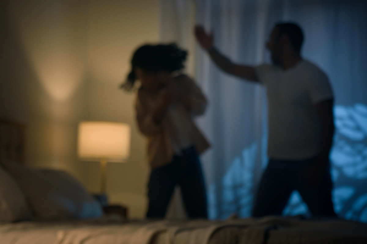 A man and woman argue in a room
