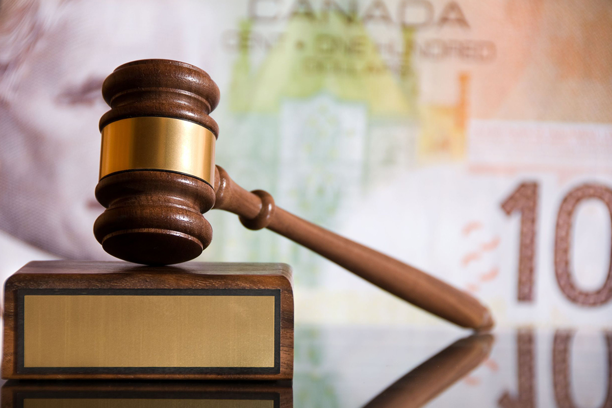 A gavel with Canadian currency
