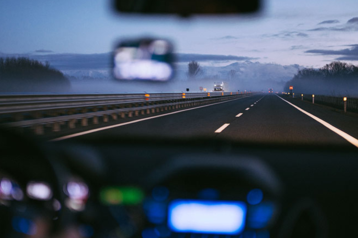 A view out of front windshield on the highway