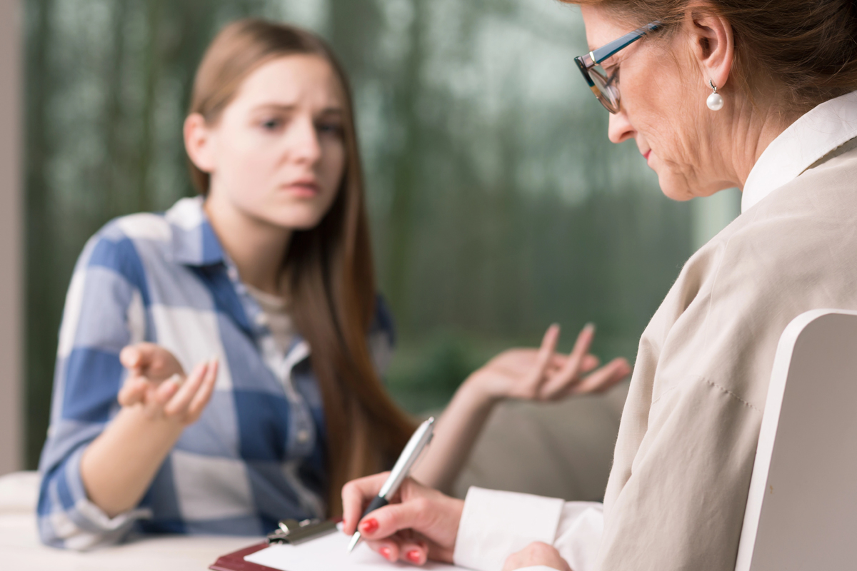 A young woman has a discussion with a parole officer