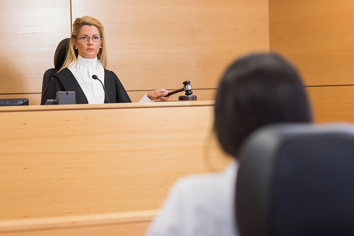 A lawyers sitting in front of a judge at trial