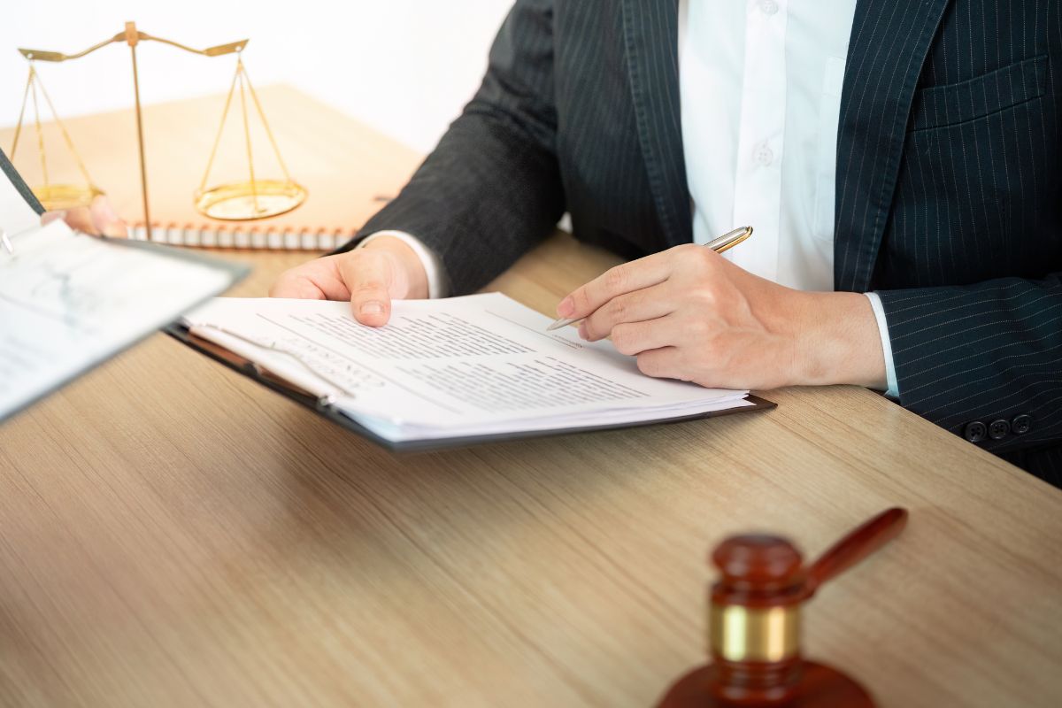 Lawyer reviewing documents at a desk.
