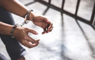 Person in handcuffs.