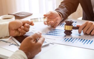 Two people discussing financial documents at a desk.