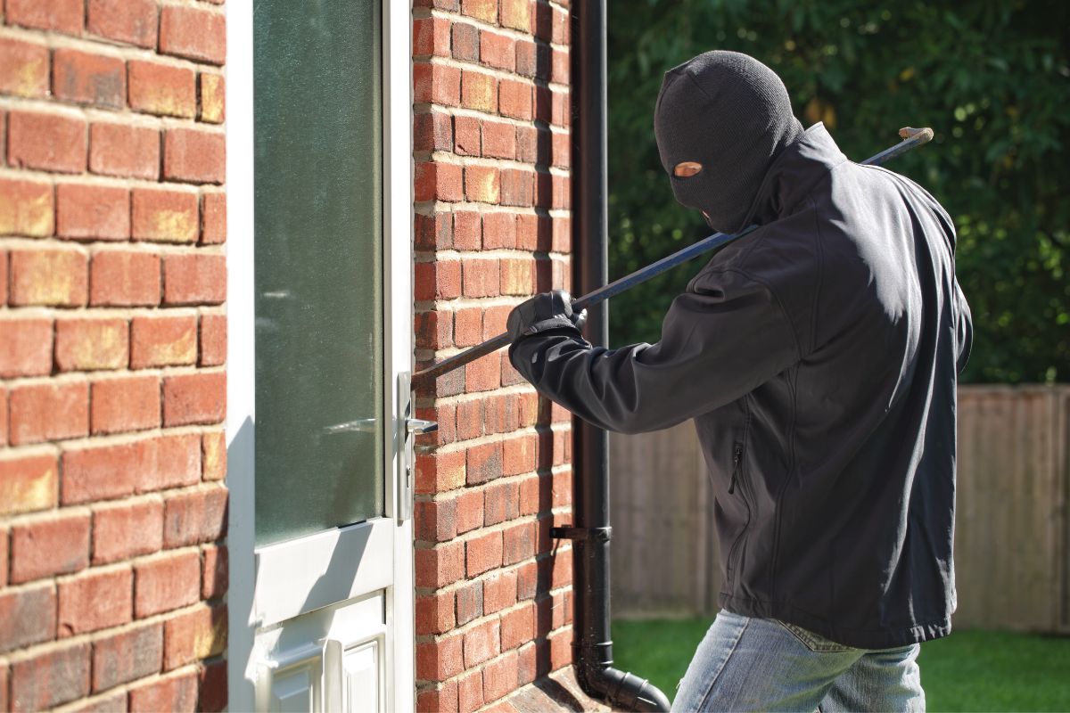 Burglar breaking into the house. Burglar breaking into the house.