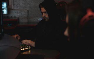 A man using a computer posing as someone else online.
