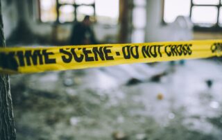 Detectives and forensics at a murder crime scene.