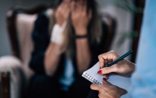 A therapist is taking notes.