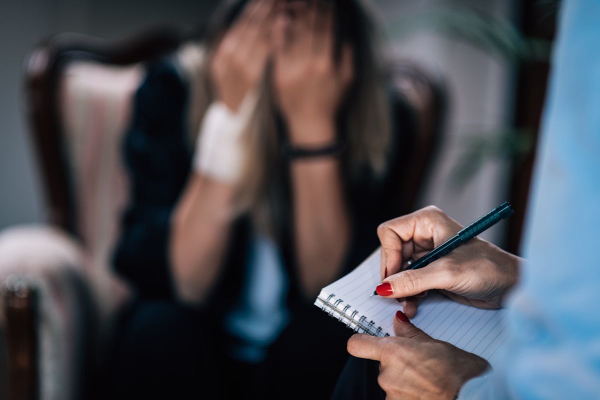 A therapist is taking notes. A therapist is taking notes.