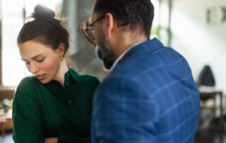 A man invading a woman's personal space indoors.
