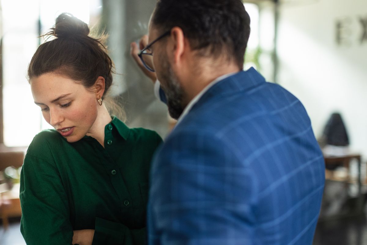 A man invading a woman’s personal space indoors. A man invading a woman's personal space indoors.