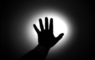 Silhouette of a hand against light.