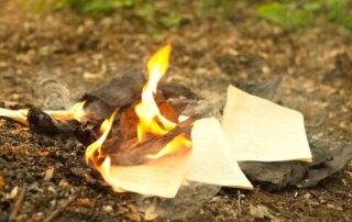 Burning papers and documents on the ground.