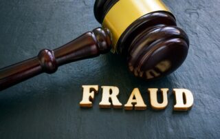 Wooden gavel beside the word "FRAUD"