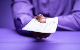 A person handing over a worthless cheque as payment.