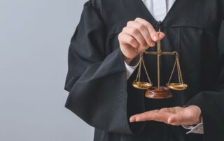 Judge holding justice scale symbolizing legal balance.