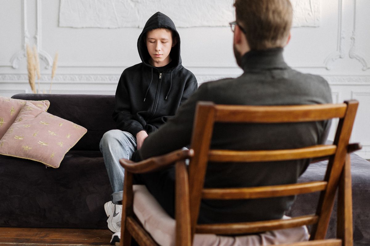 A man sitting on a couch during a one-on-one counselling session. A man sitting on a couch during a one-on-one counselling session.