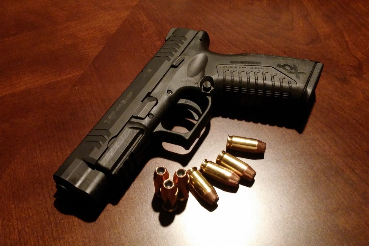 Black handgun with bullets. Black handgun with bullets.