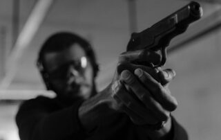 Man aiming a handgun.