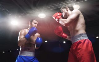 Two male boxers facing off in a boxing ring.