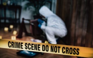 Crime scene and investigator examining evidence.