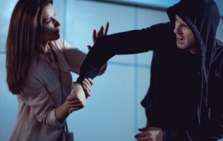 A woman defending herself from an aggressive man.