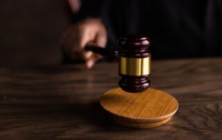 Gavel on judge’s bench in courtroom.