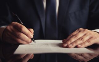 Person signing legal document.